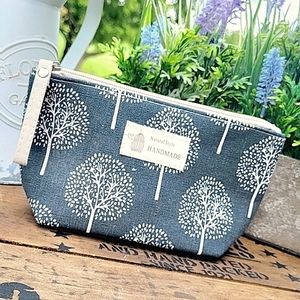 Cute, cosmetic bag. Zippered closure, flat bottom. Pretty Blue Gray color  New
